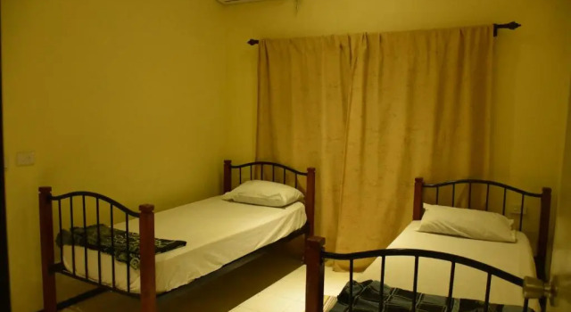 Кровать в общем номере с красивым видом из окна Westfield Homestay Fiji