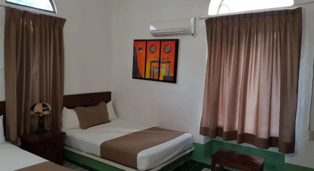 Кровать в общем номере Hotel Hacienda de Melaque