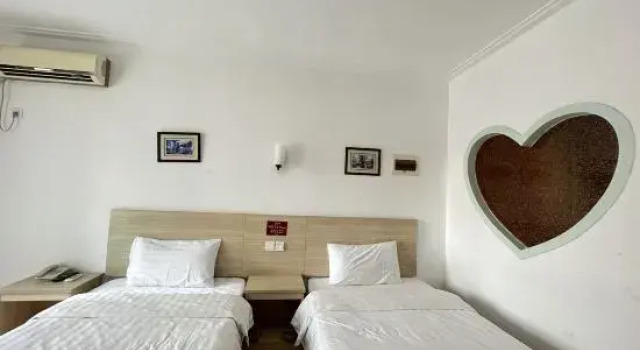 Кровать в общем номере Shenyang Pangjiang Hotel