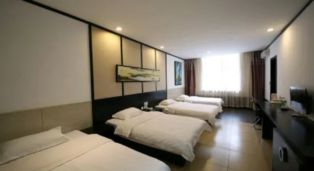 Łóżko w pokoju wieloosobowym Tai 9 Hotel (duelbert)