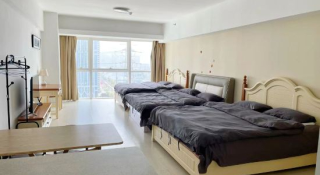 Кровать в общем номере с видом на море Dalian Xinghai Micro Lan Xiaozhu Apartment