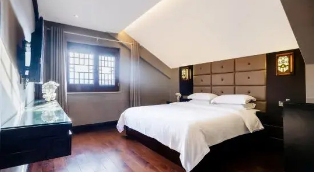 Кровать в общем номере Wuyishan Ruting Yayuan Homestay (Yueying Wuyi Theater)