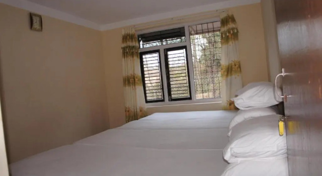 Кровать в общем номере Mount Paradise Nature Stay