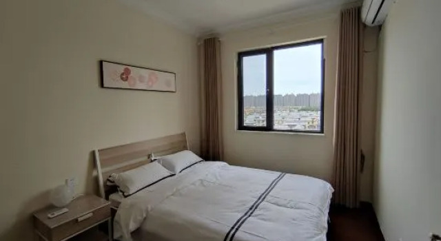 Кровать в общем номере с 3 комнатами Qidong Henghai Coast Apartment