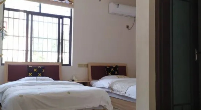 Кровать в общем номере Xunmeng Huizhou Inn