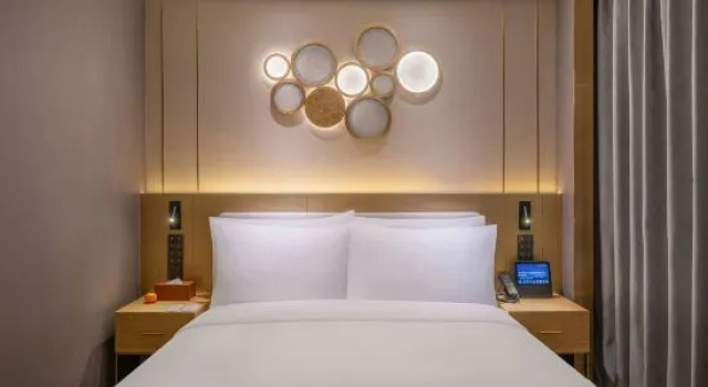 Кровать в общем номере Orange Hotel Wuhan Chuhehan Street