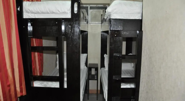 Кровать в общем номере New Guangzhou Guest House