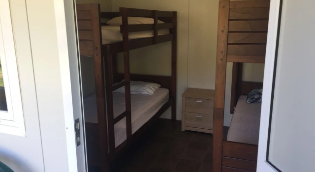 Кровать в общем номере Port Waikato Holiday Park