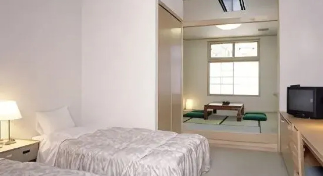 Кровать в общем номере Miyagawa Onsen Hida Manga Okoku