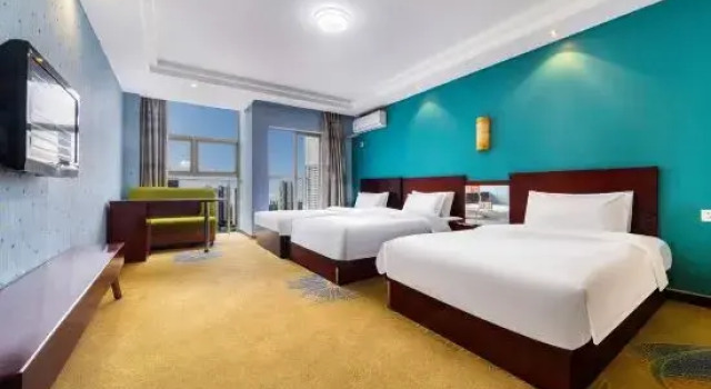 Кровать в общем номере Wanmao Business Hotel