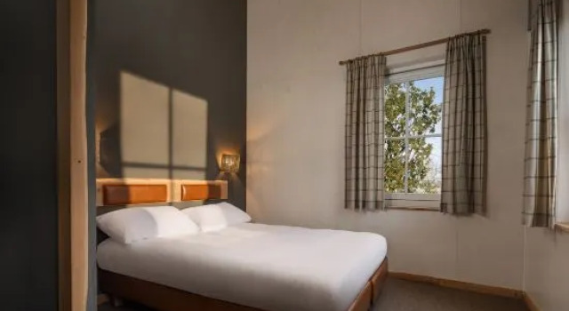Кровать в общем номере Efteling Loonsche Land Hotel