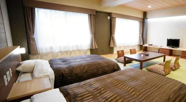 Кровать в общем номере Hotel Daiheigen