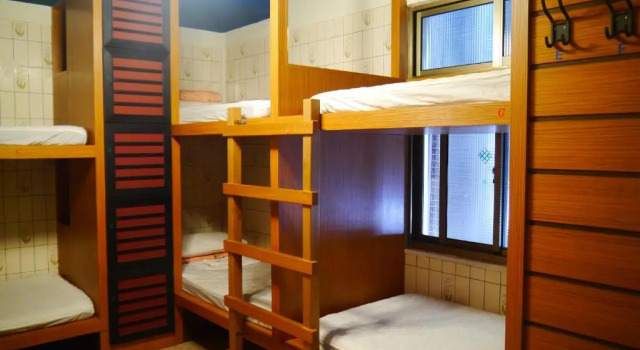 Кровать в общем номере Hsin Hsin Hotel