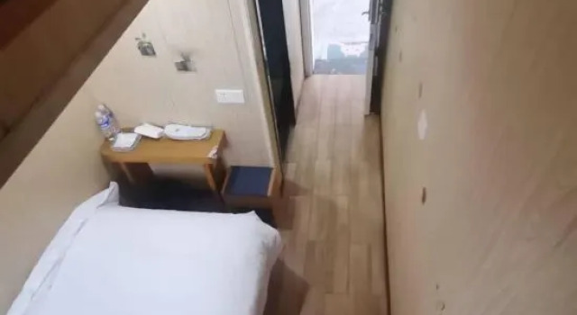 Кровать в общем номере shangpin hotel