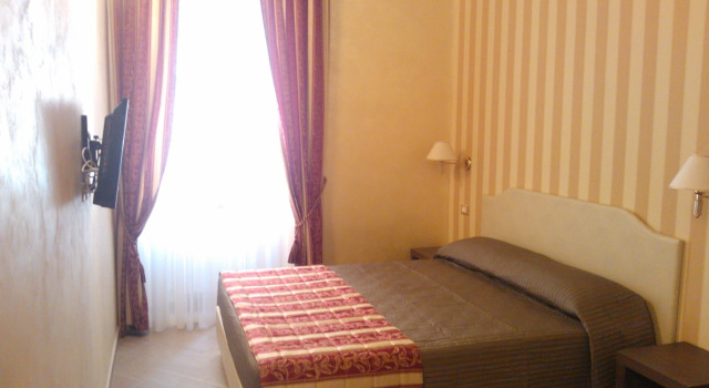 Кровать в общем номере Excellence Suite