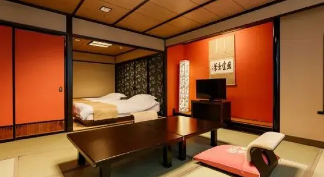 Кровать в общем номере Aiken to Sugosu Honkaku Ryokan Gekka
