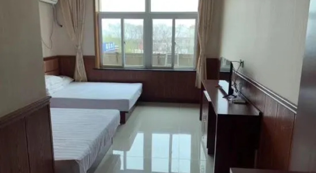 Кровать в общем номере Yuzhong Xingshun Hotel