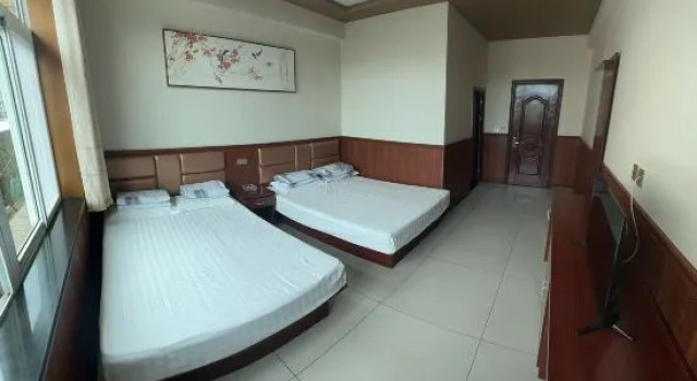 Кровать в общем номере Yuzhong Xingshun Hotel