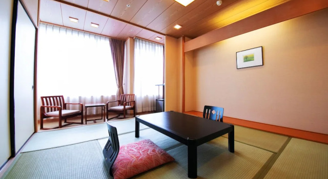 Кровать в общем номере Kesennuma Plaza Hotel