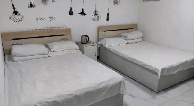 Кровать в общем номере Qiqihar Dadi Hotel