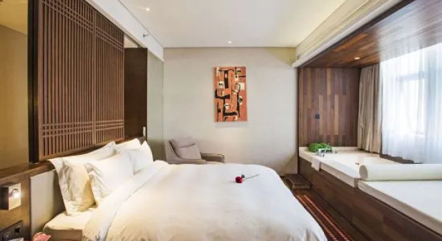 Łóżko w pokoju wieloosobowym Manyue Select Holiday Hotel