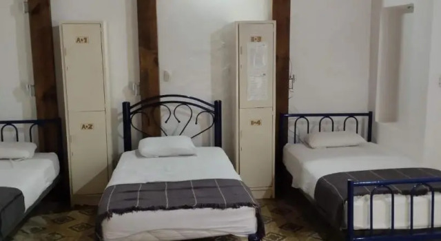 Кровать в общем номере Hostal San Pueblo