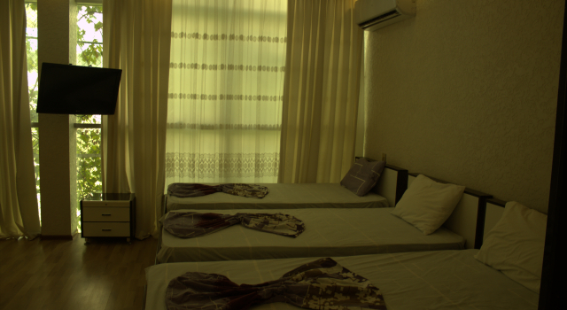 Łóżko w pokoju wieloosobowym Ruslan Hotel