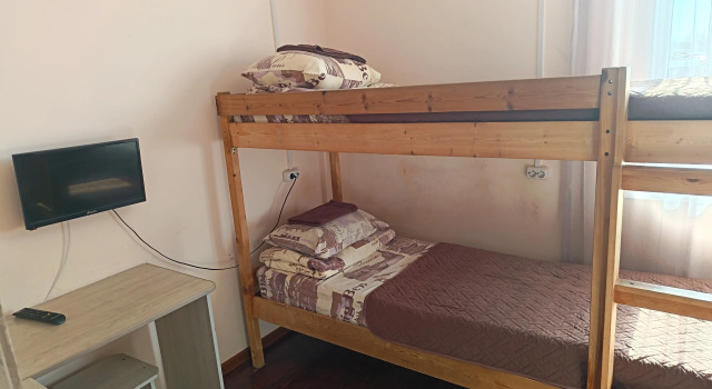 Кровать в общем номере Отель Альфа