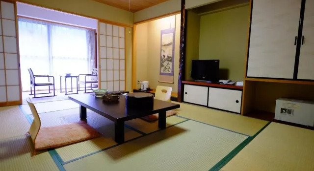Кровать в общем номере Okuhida Garden Hotel Yakedake