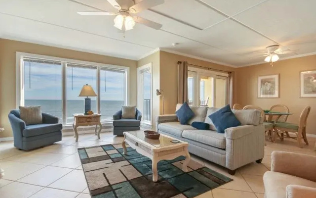 Coast View Condo Featuring Large Windows Overlooking the Beach by RedAwning