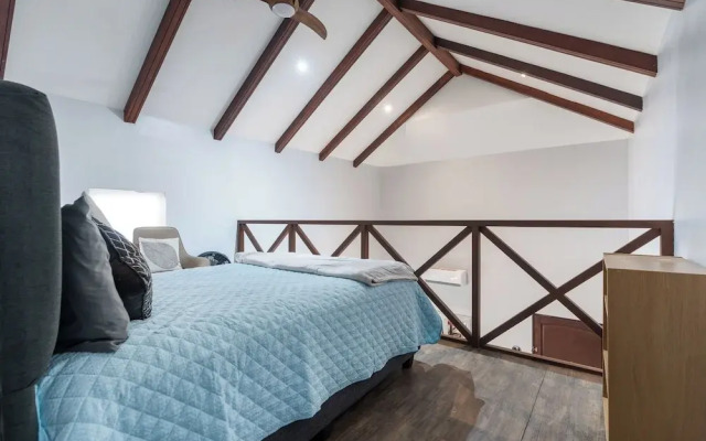 Modern Island-Themed Condo with Floor-to-Ceiling Windows & Garden and Pool Views Within Walking Distance of the Beach