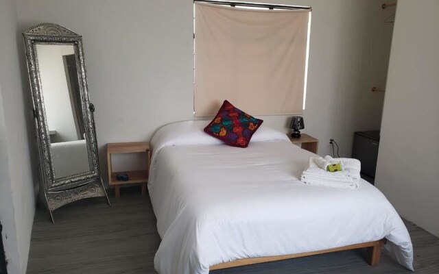 Отель Hermila Tlalpan Suites Мехико комната для гостей