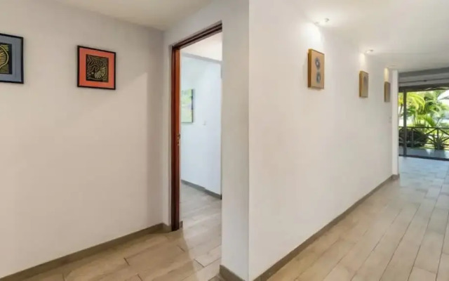 Elegant Condo with Brand-New Fixtures, Shaded Tropical Terrace, and Secluded Beach Access