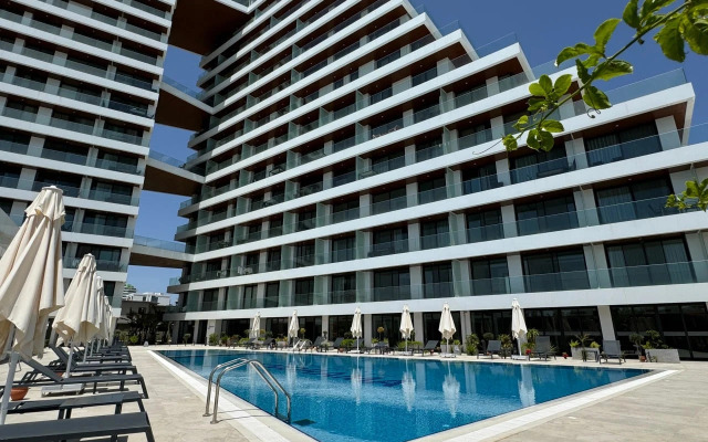 Апартаменты Stylish 1BR Sea View in Longbeach Iskele